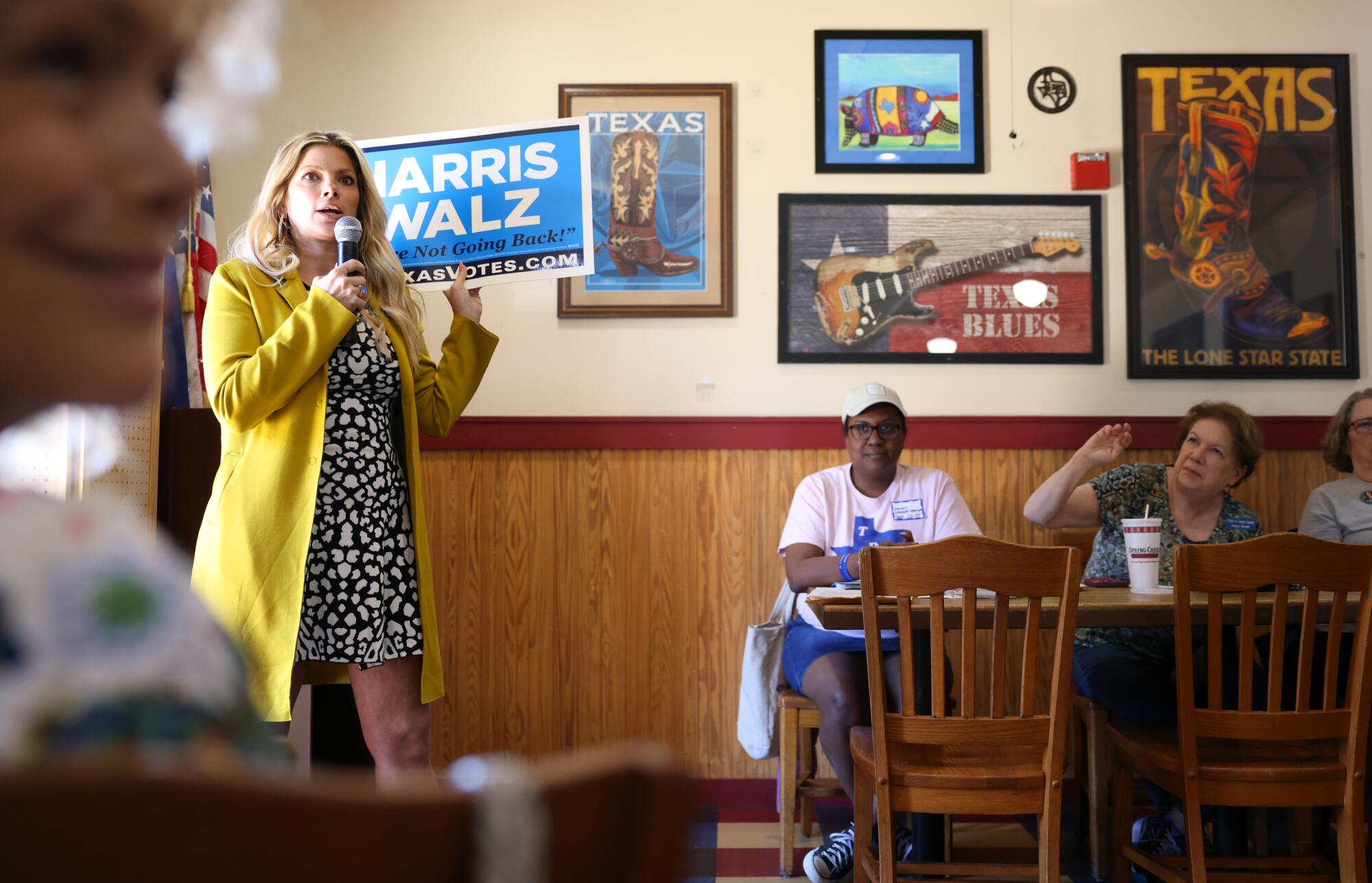 A woman speaks to a group  