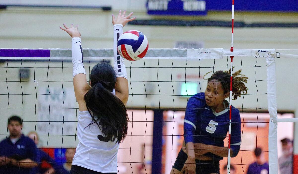 Venice outside hitter Gaia Adeseun-Williams (5) drives a spike past a blocker during a recent match.