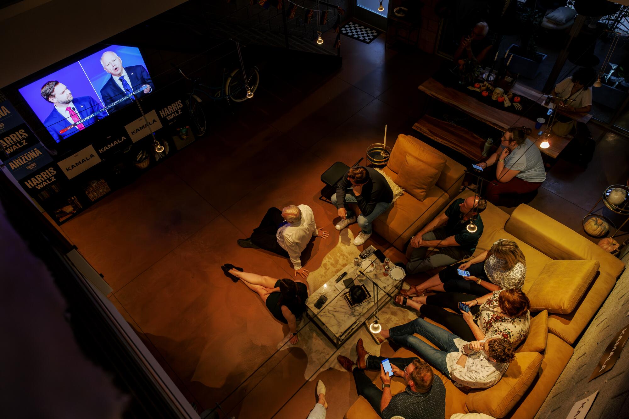 Several people gather to watch the vice presidential debate in Phoenix.