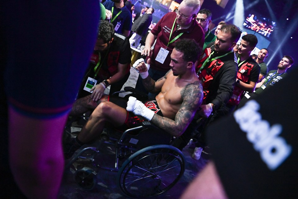 The fighter fell out of the ring and left the venue in a wheelchair