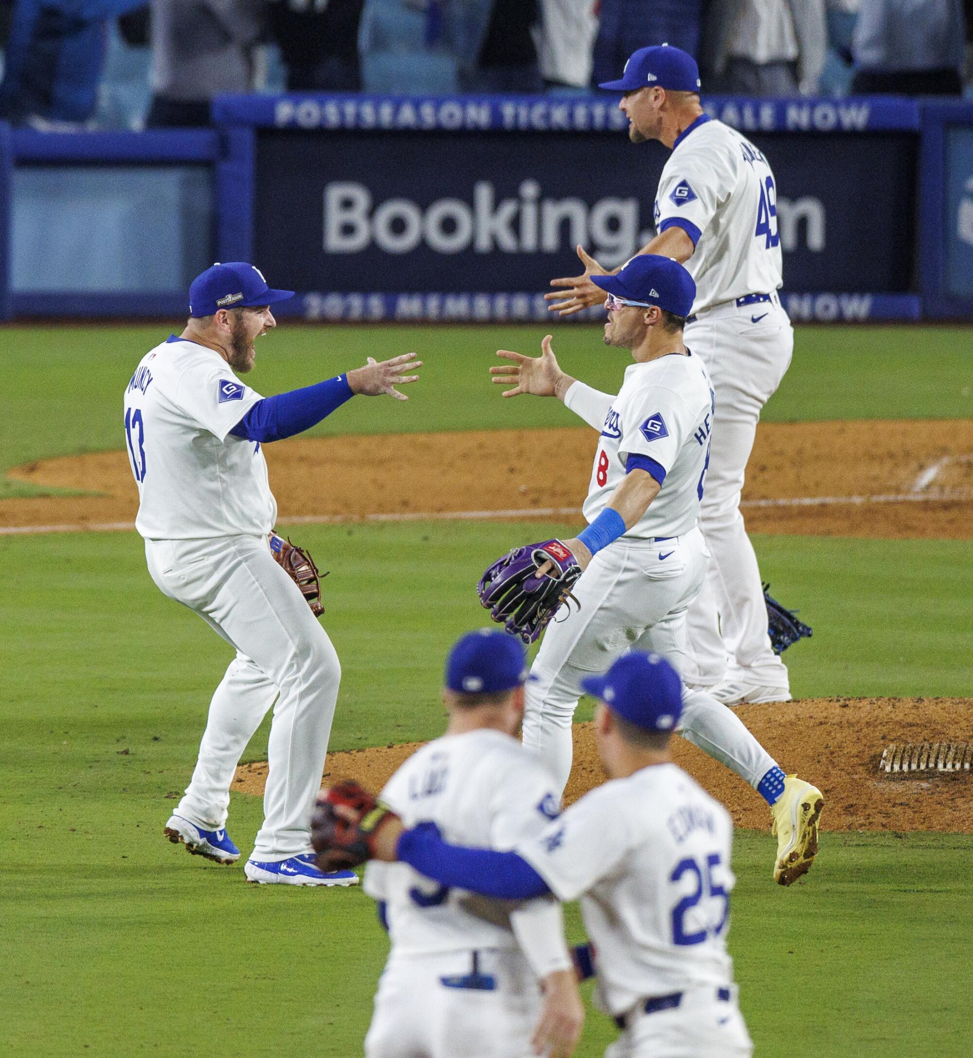 Dodgers celebrate on the field after the team beat the Padres and won the NLDS series on Friday 