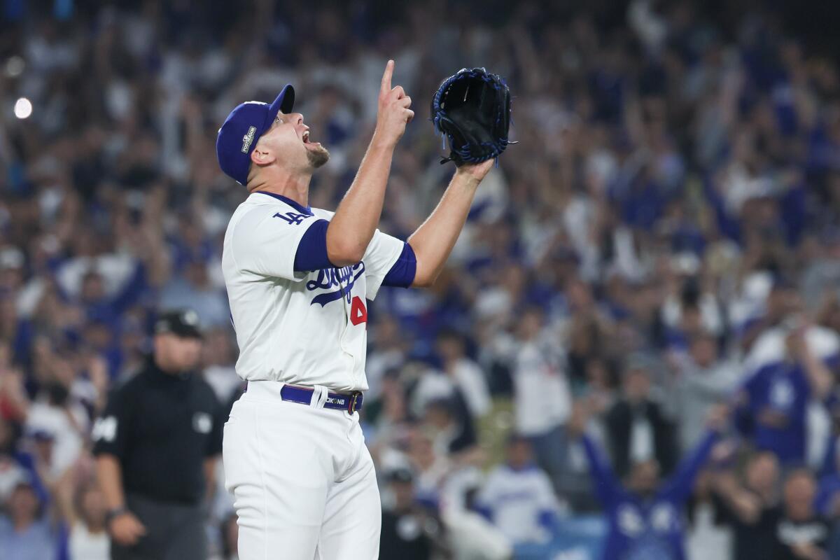 Blake Treinen raises his arms as he points to the sky after earning a save in Game 1 of the division series