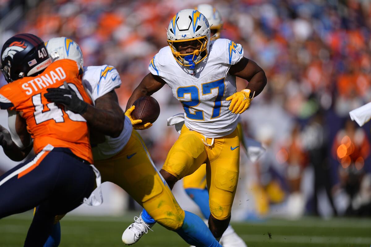  Chargers running back J.K. Dobbins (27) runs against the Denver Broncos.