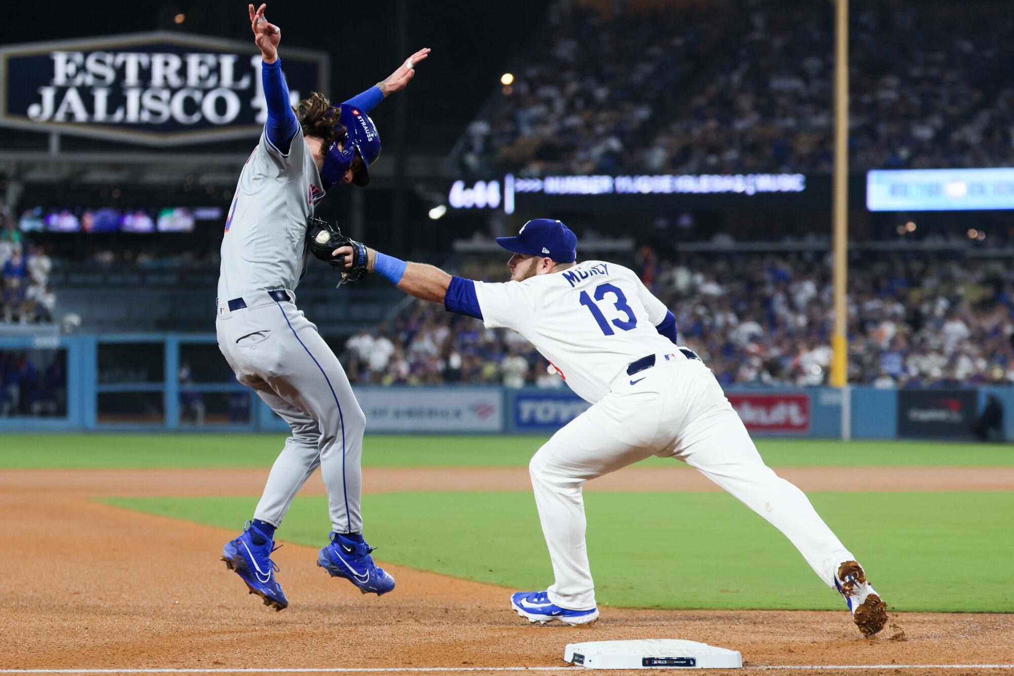 Dodgers third baseman Max Muncy tags out Mets baserunner Jesse Winker in the fifth inning Sunday.