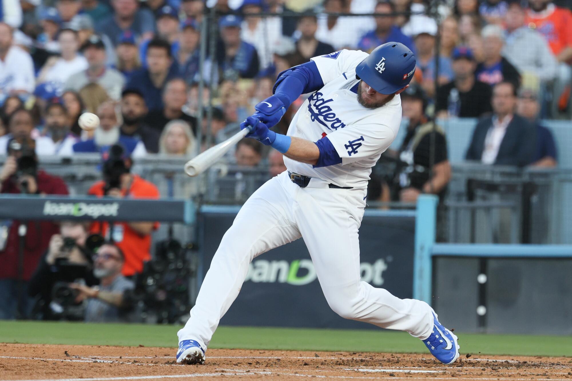 Max Muncy hits a two-run single for the Dodgers in the first inning of Game 1 of the NLCS on Sunday.