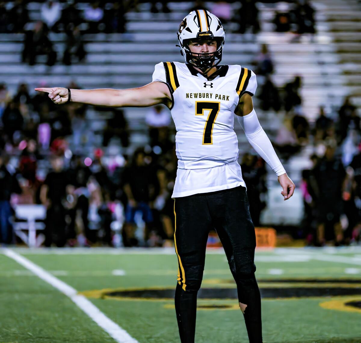 Quarterback Brady Smigiel of Newbury Park signals first down.