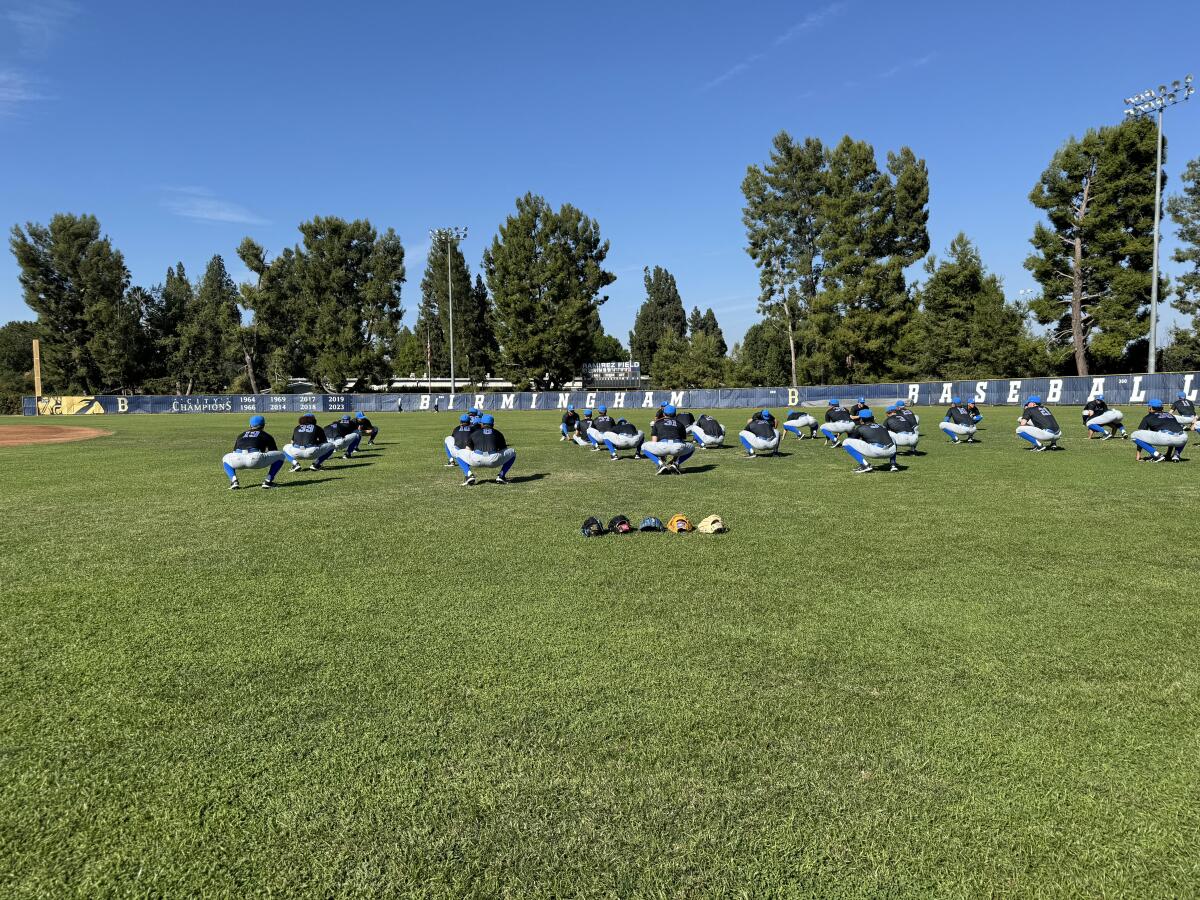 UCLA's baseball team stretches at Birmingham High on Thursday before practicing. 