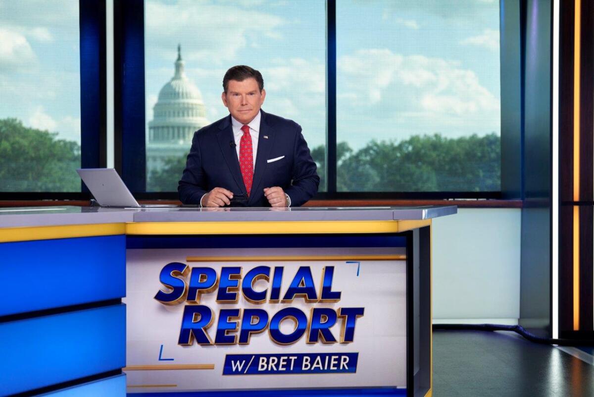 Bret Baier sits behind an anchor desk with the words "Special Report" on it, the Capitol dome visible behind him.