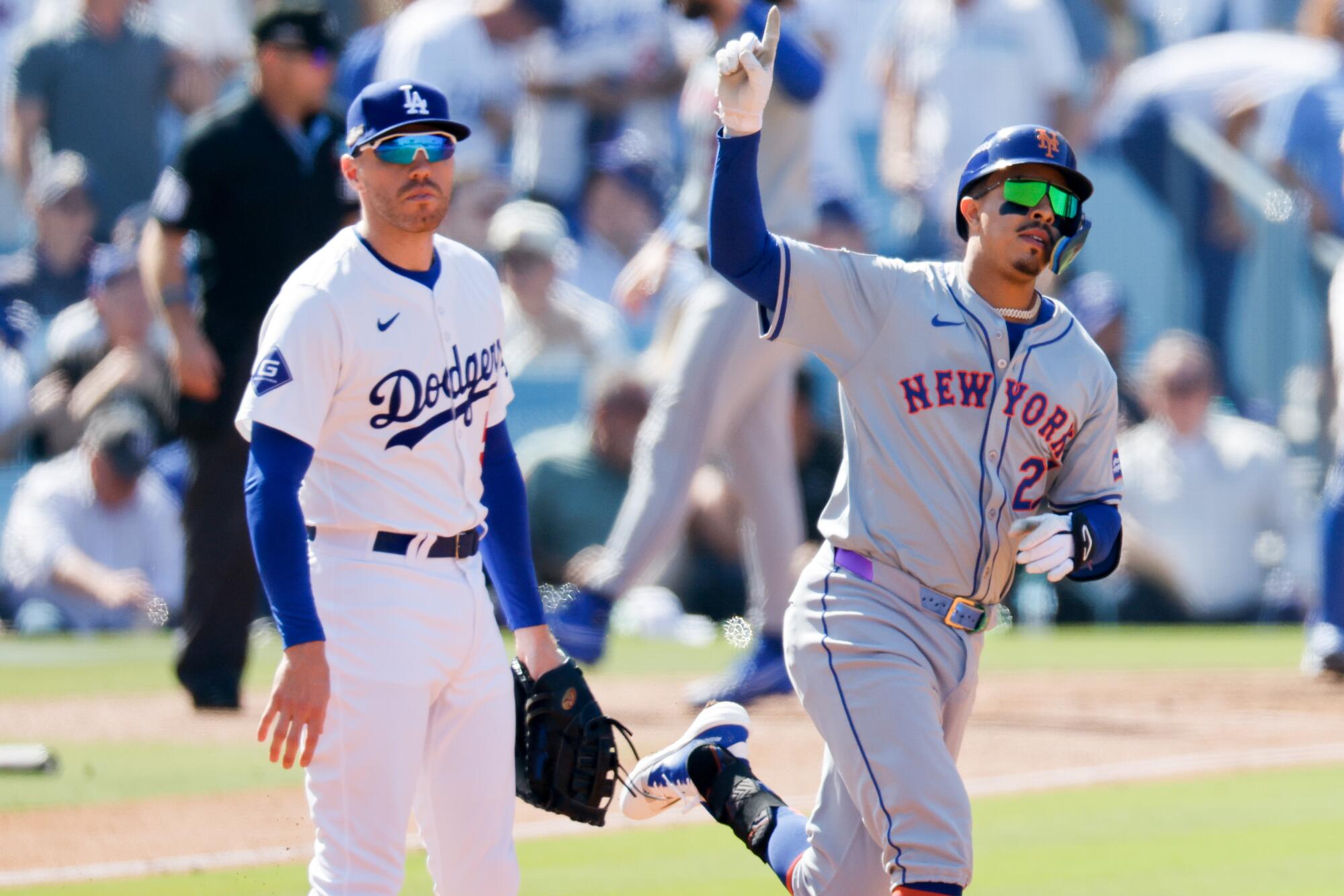 New York's Mark Vientos celebrates as he runs past Dodgers first baseman Freddie Freeman after hitting a grand slam.