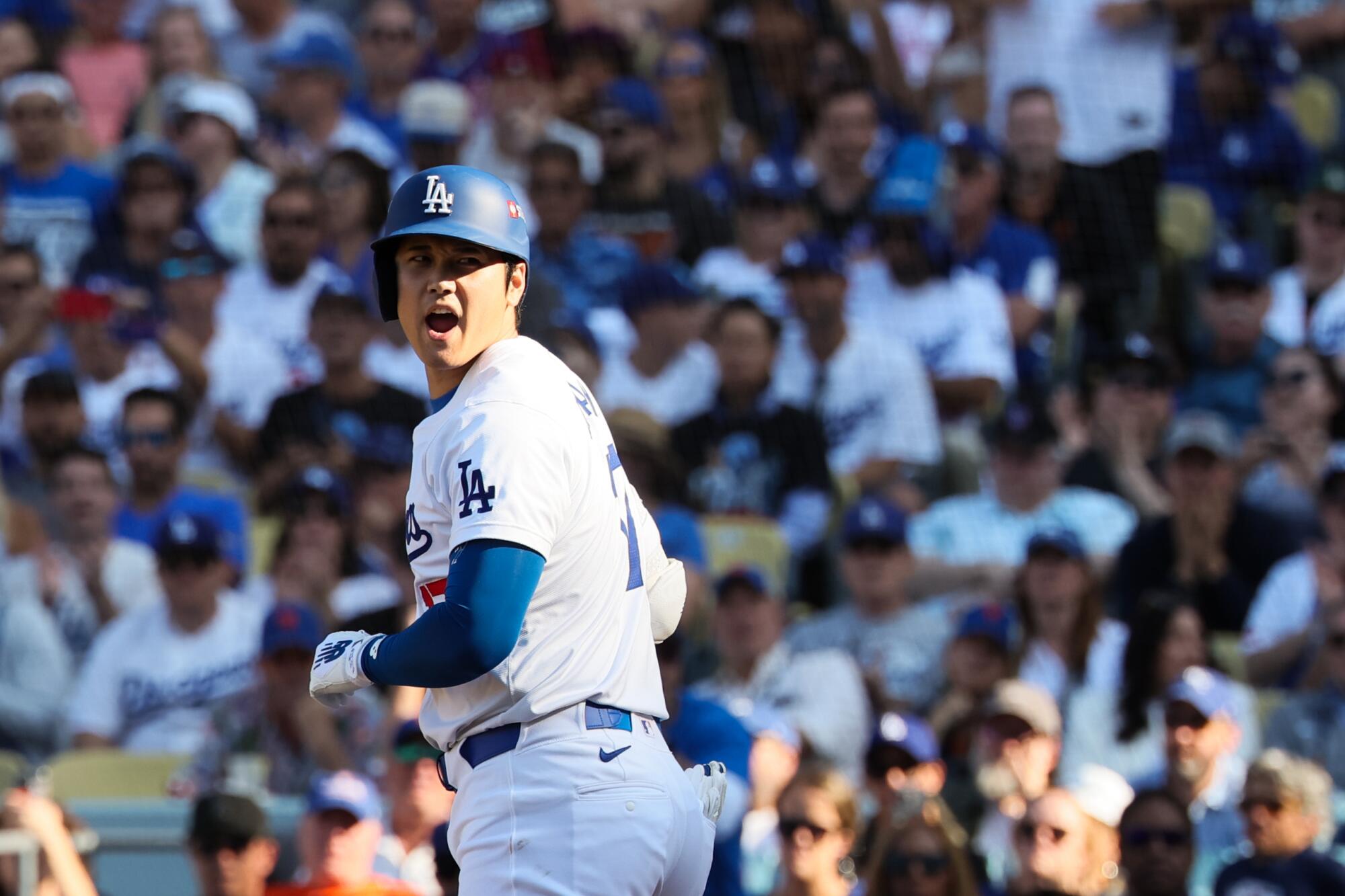 Shohei Ohtani heads to first base after drawing a walk in the seventh inning of Game 2 of the NLCS on Monday.