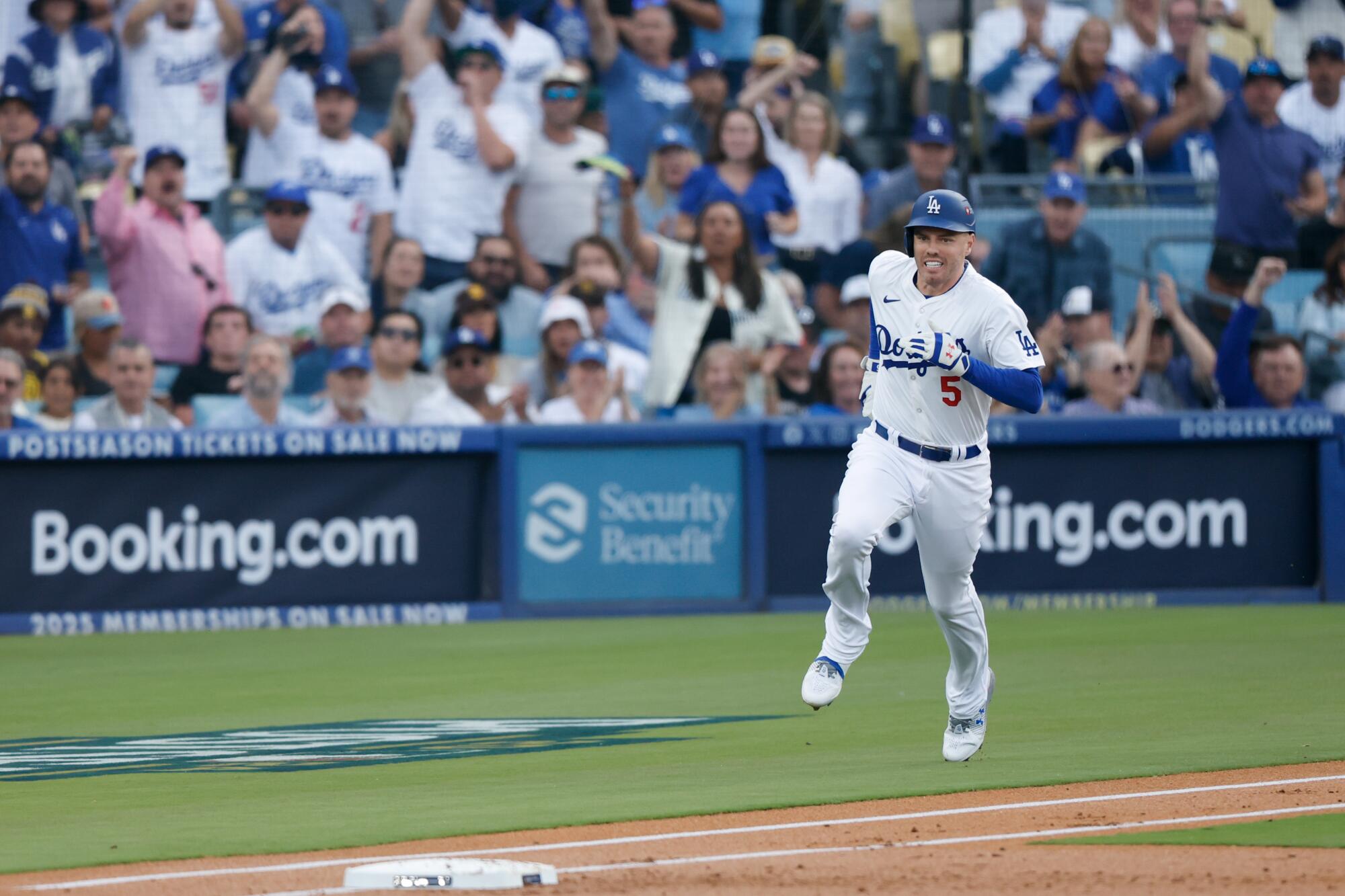 Dodger Freddie Freeman runs to first after hitting a single during the first inning of Game 5 of the NLDS