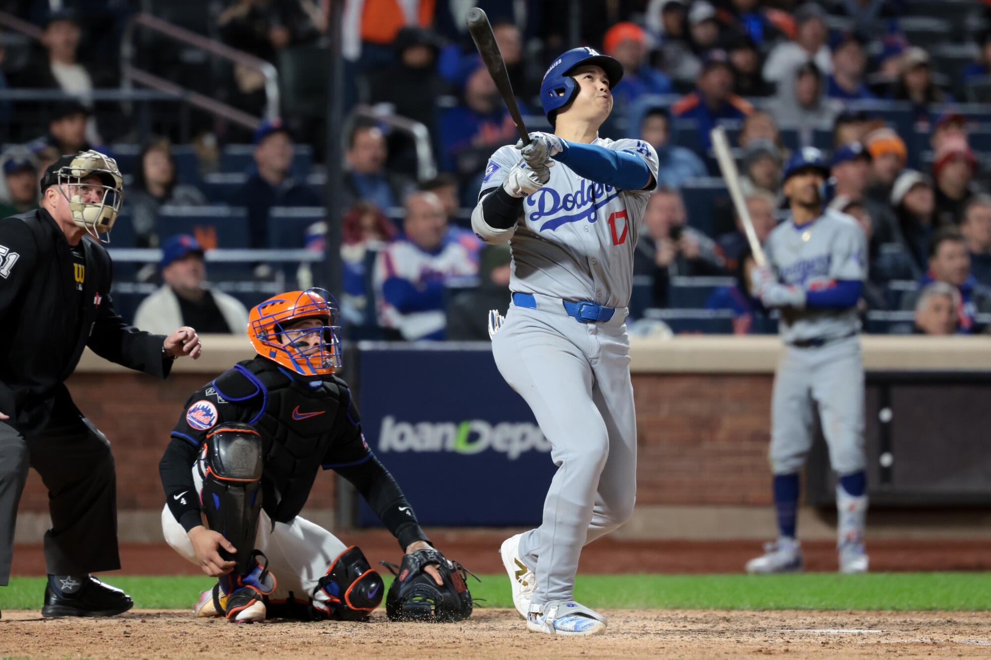 Dodgers star Shohei Ohtani hits a three-run home run in the eighth inning of an 8-0 win over the Mets on Wednesday.