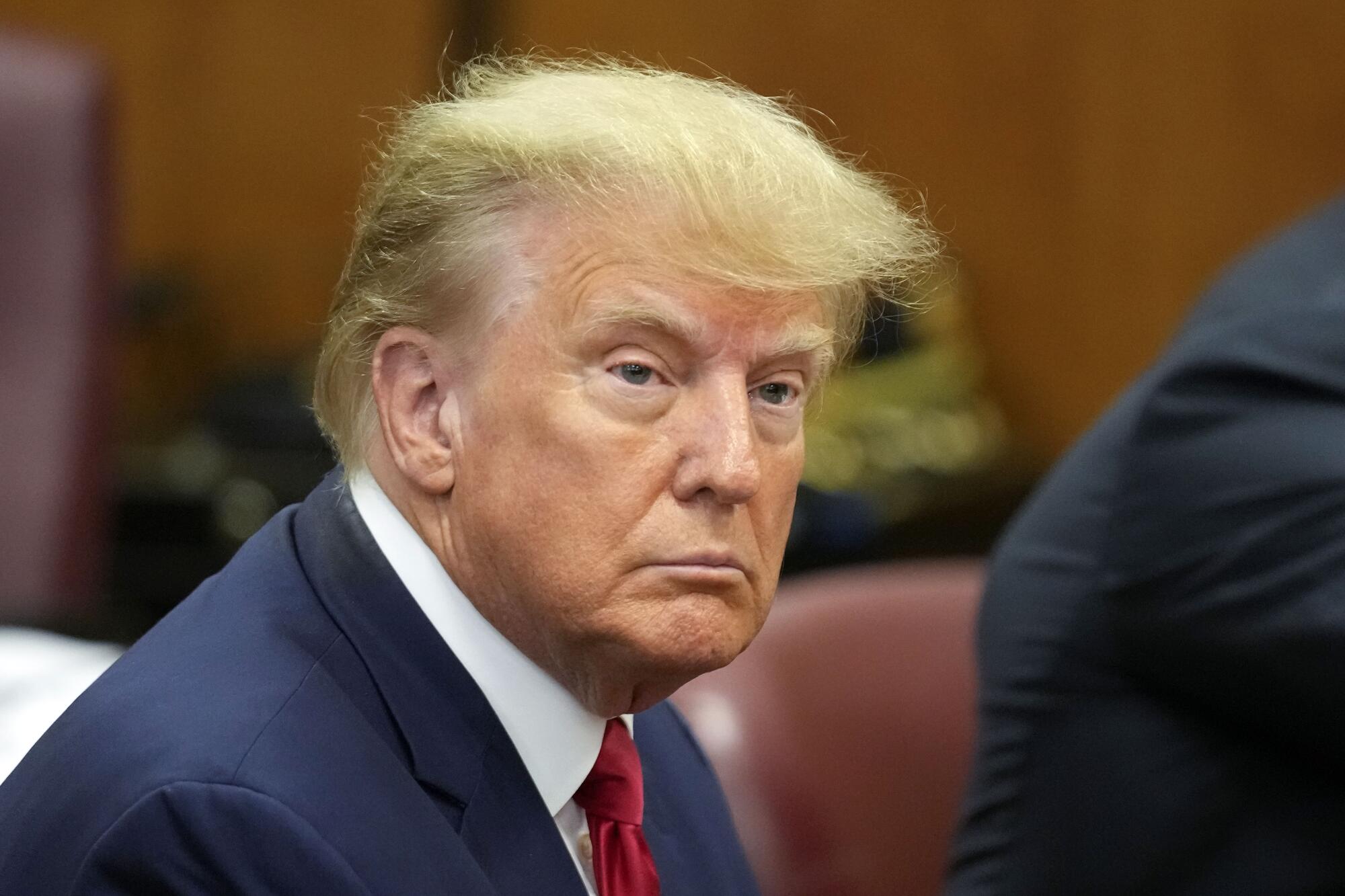 Donald Trump seated in court