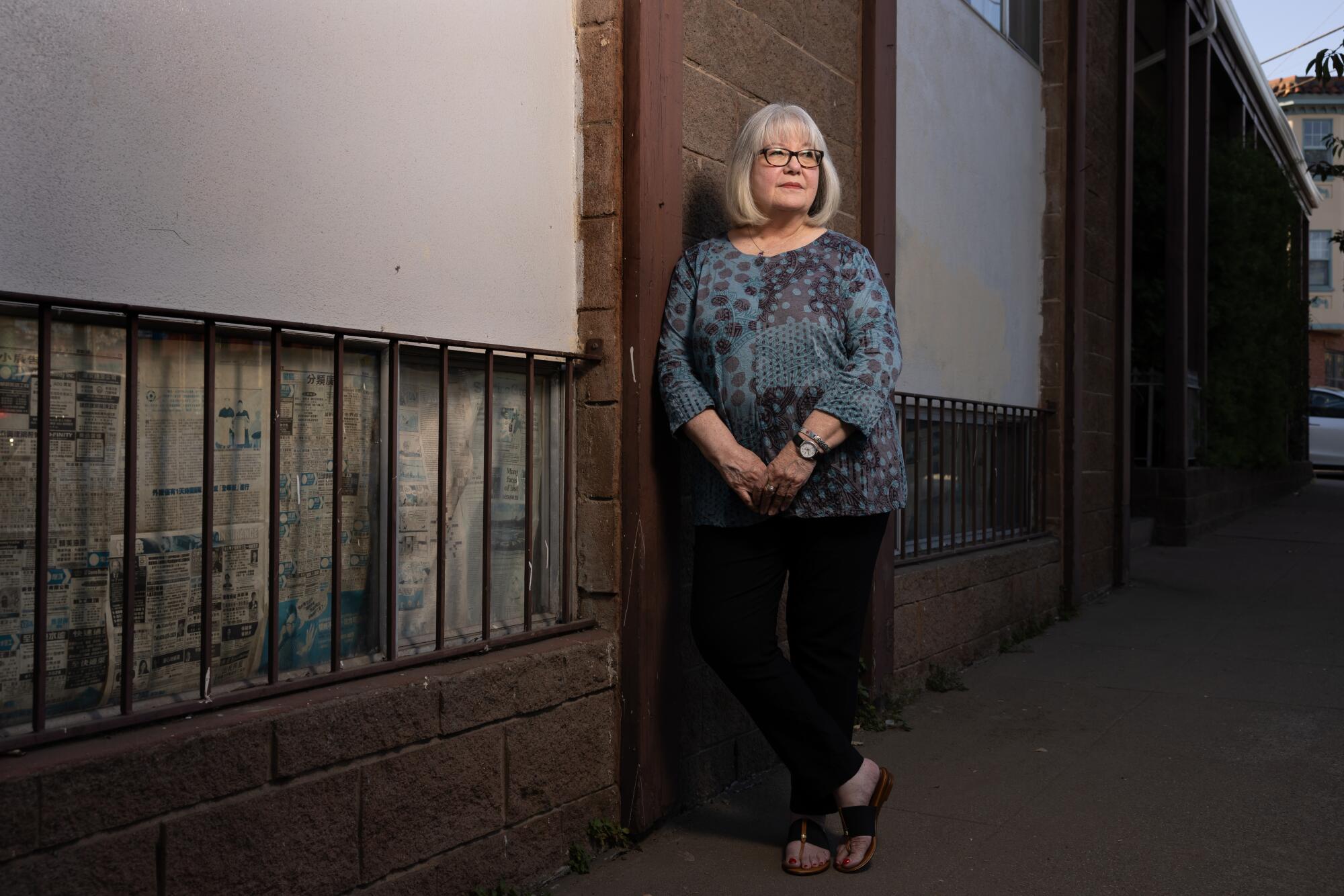 Frances Sheehan standing next to a building.