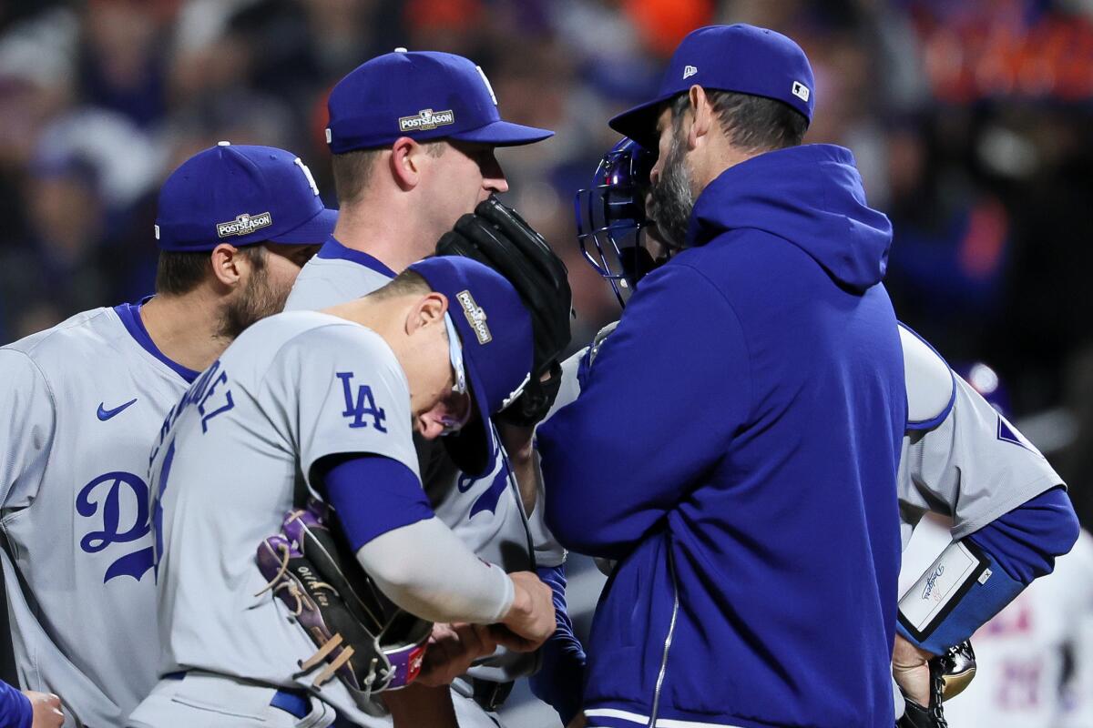 Dodgers reliever Evan Phillips speaks with pitching coach Mark Prior during the sixth inning Thursday against the Mets.