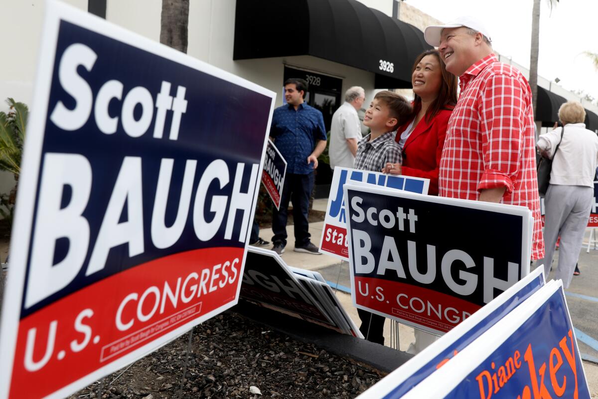 Scott Baugh and Janet Nguyen take a photo together near his campaign signs