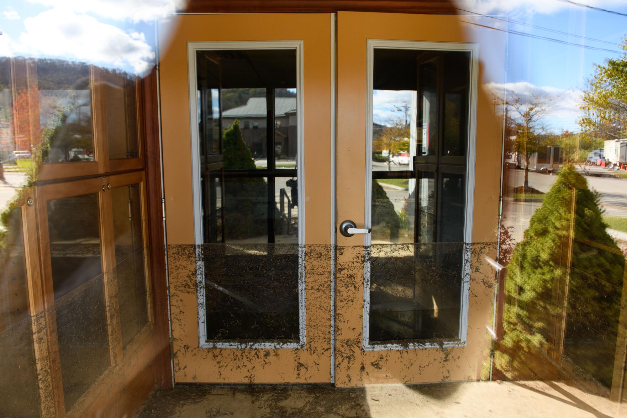 The Avery County Senior Center entrance is seen with a water mark several feet above the ground from flooding and debris.