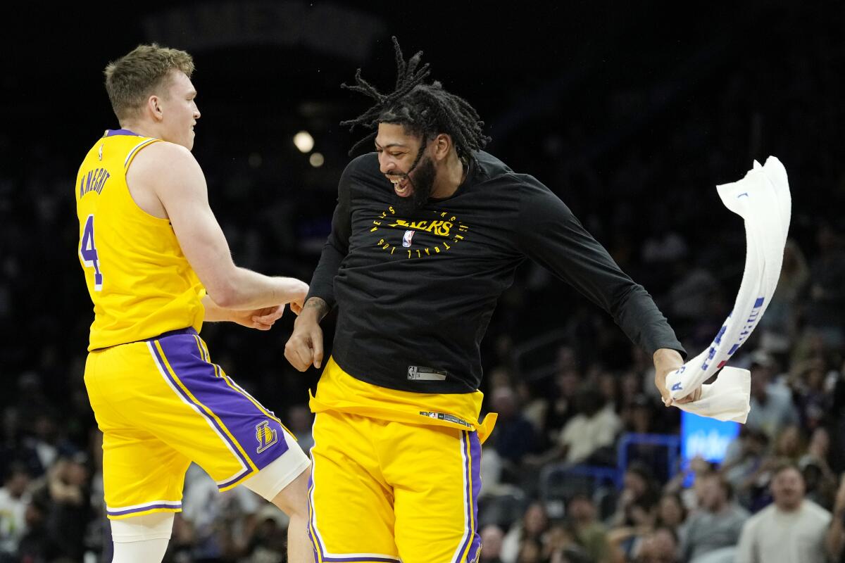 Lakers star Anthony Davis, right, celebrates with rookie guard Dalton Knecht after he made a three-pointer against the Suns.