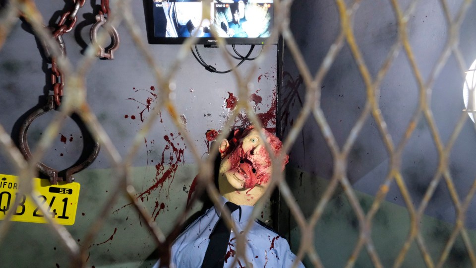 A gruesome dead security guard model greets brave visitors as they dare to enter