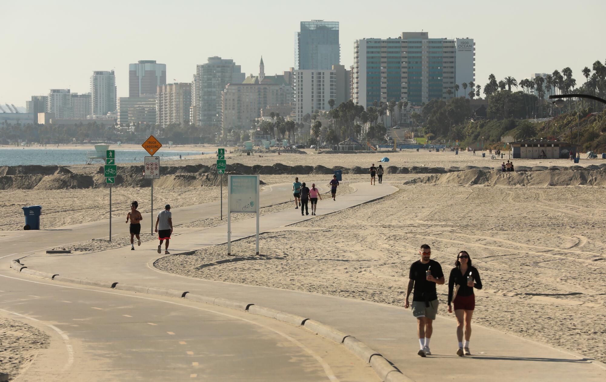 The bike and pedestrian path on the beach in Long Beach, with downtown's skyline behind.