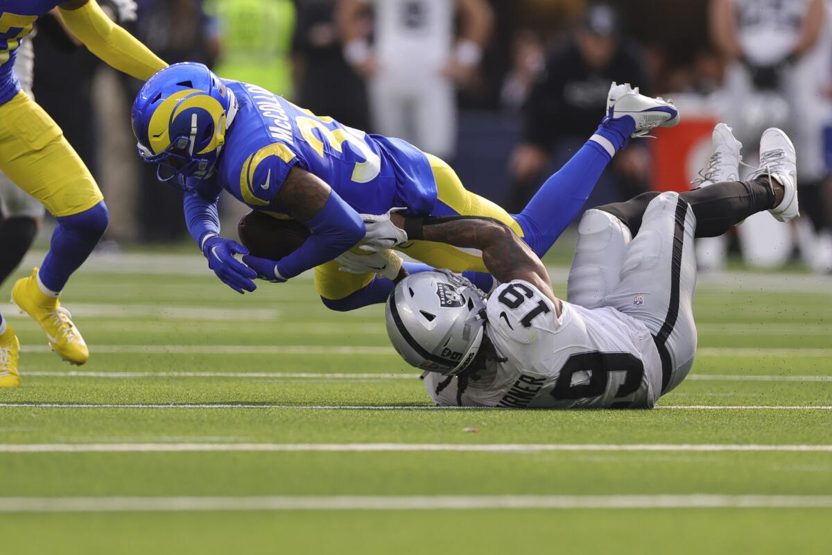 Rams safety Jaylen McCollough (39) intercepts a pass intended for Raiders wide receiver DJ Turner (19).