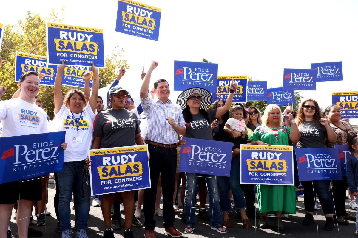 Former California Assemblymember Rudy Salas, center, stands with supporters of his congressional campaign.