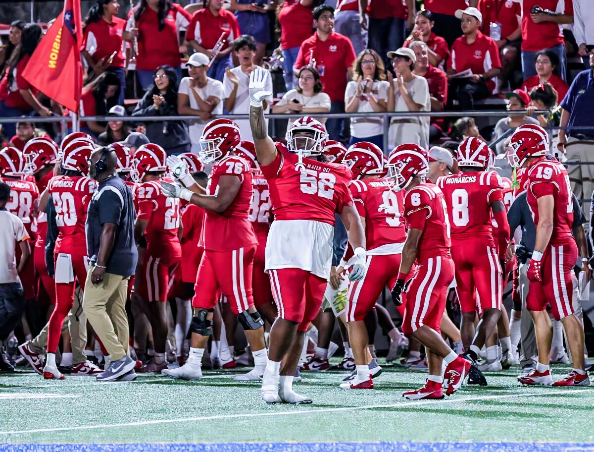 Mater Dei's Tomuhini Topui (52) starts celebration in win over Bishop Gorman.