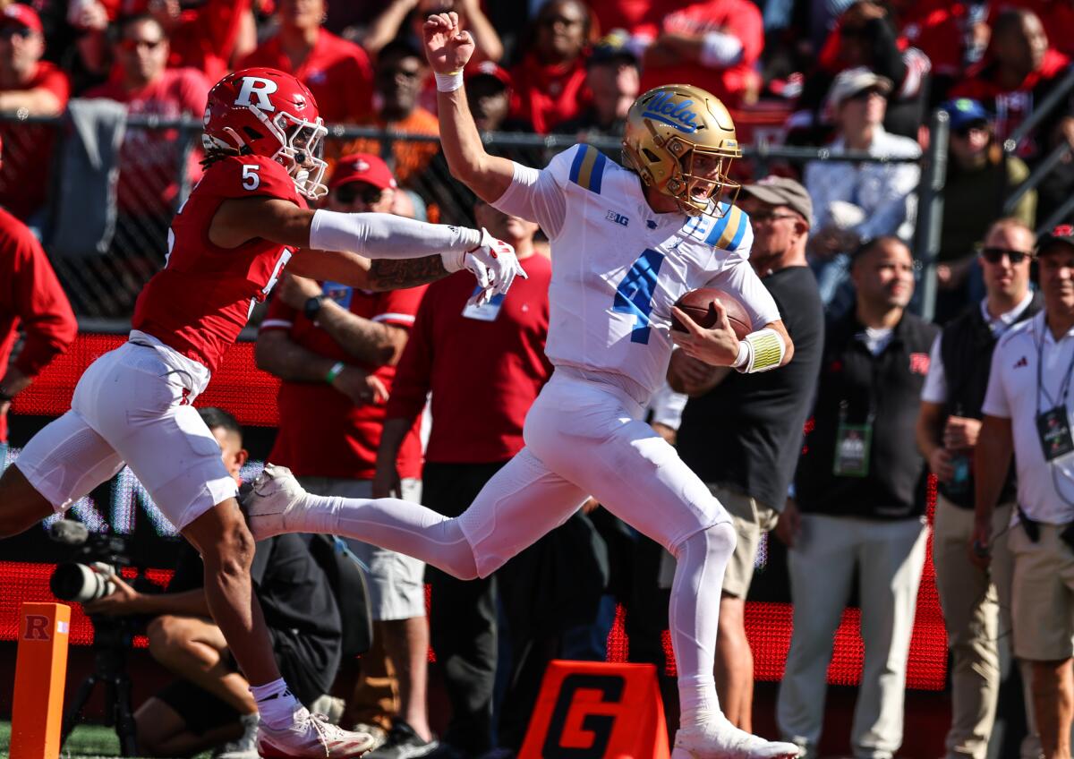 UCLA quarterback Ethan Garbers outruns a defender for a 48-yard touchdown against Rutgers.