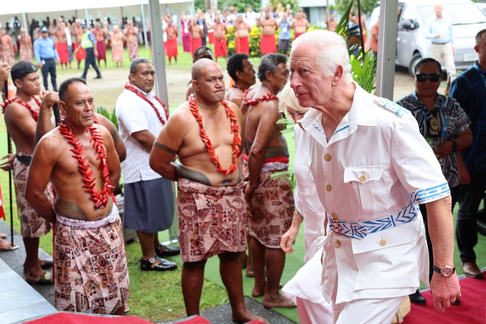 Village community members greet the King at the National University of Samoa in Apia