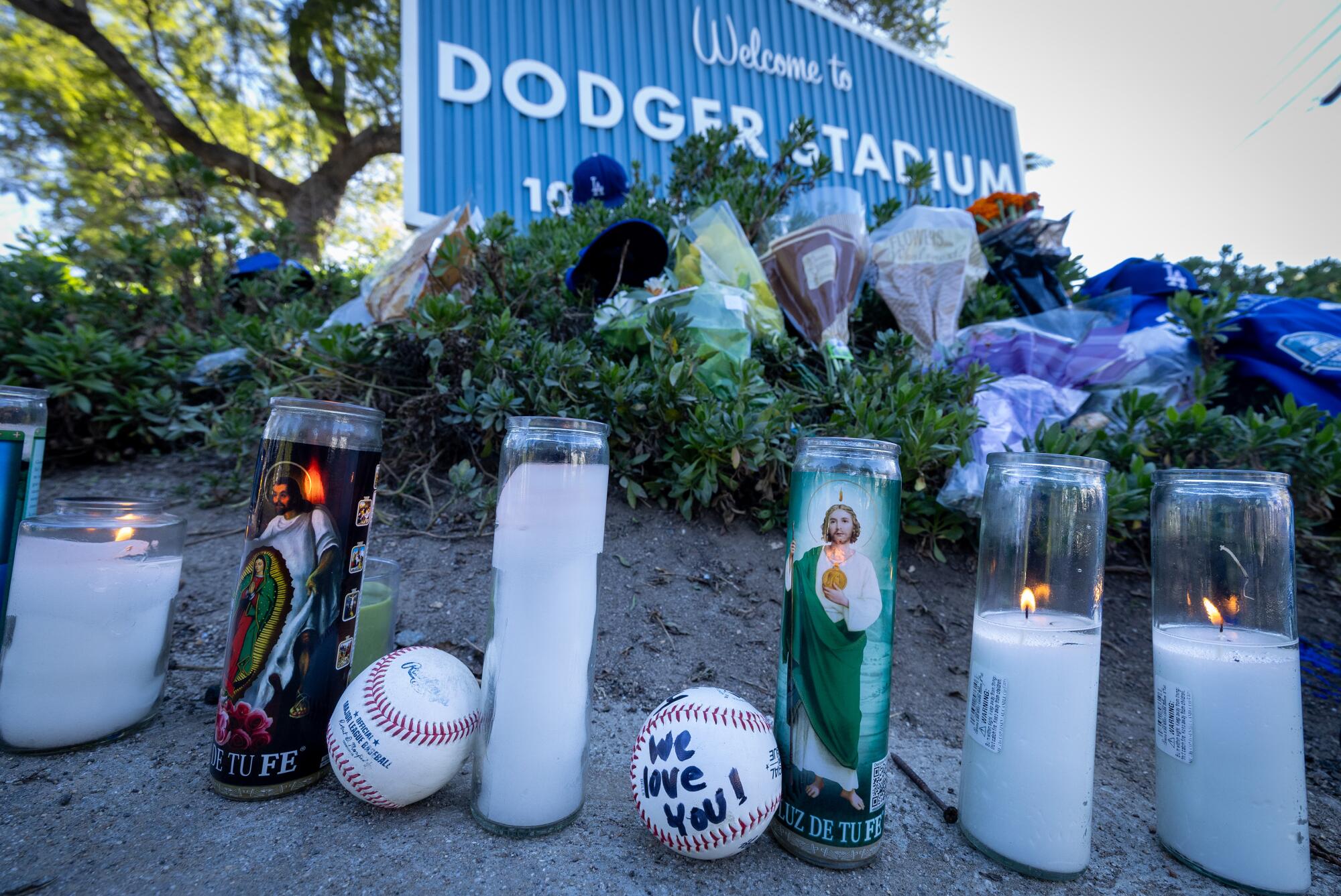 Fans placed flowers, candles, baseball and other gifts at the gates of Dodger Stadium in honor of Fernando Valenzuela.