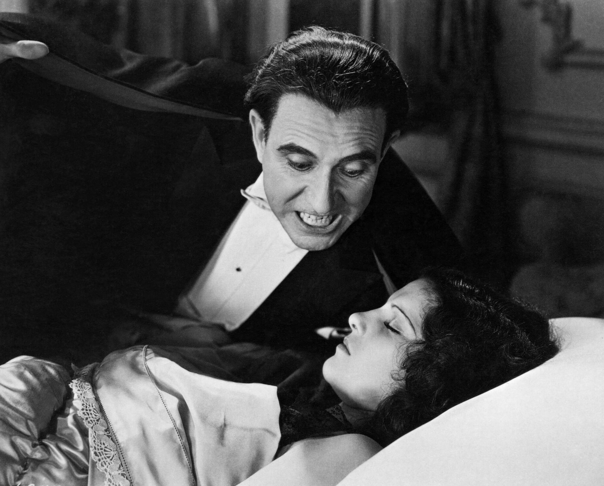 Carlos Villarías as Dracula looms over a sleeping Lupita Tovar.