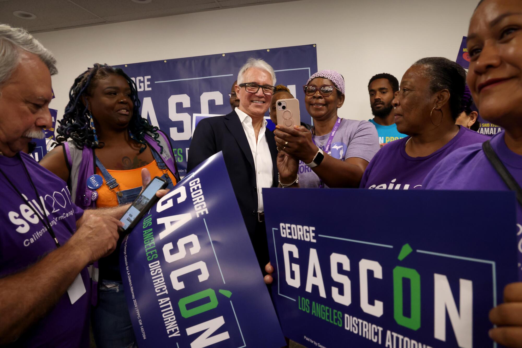 George Gascon takes a selfie with supporters