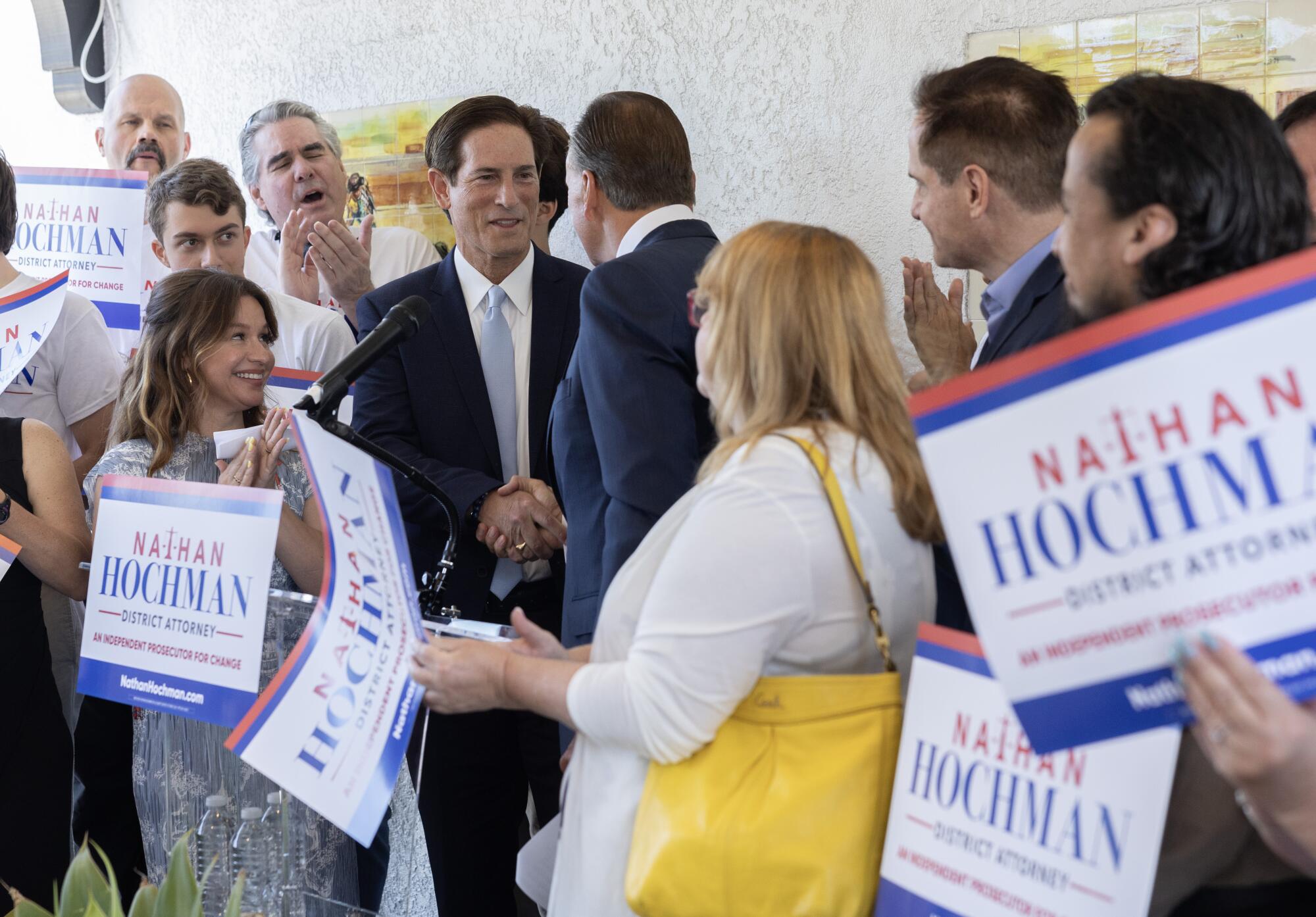 Nathan Hochman shakes hands with Rick Caruso