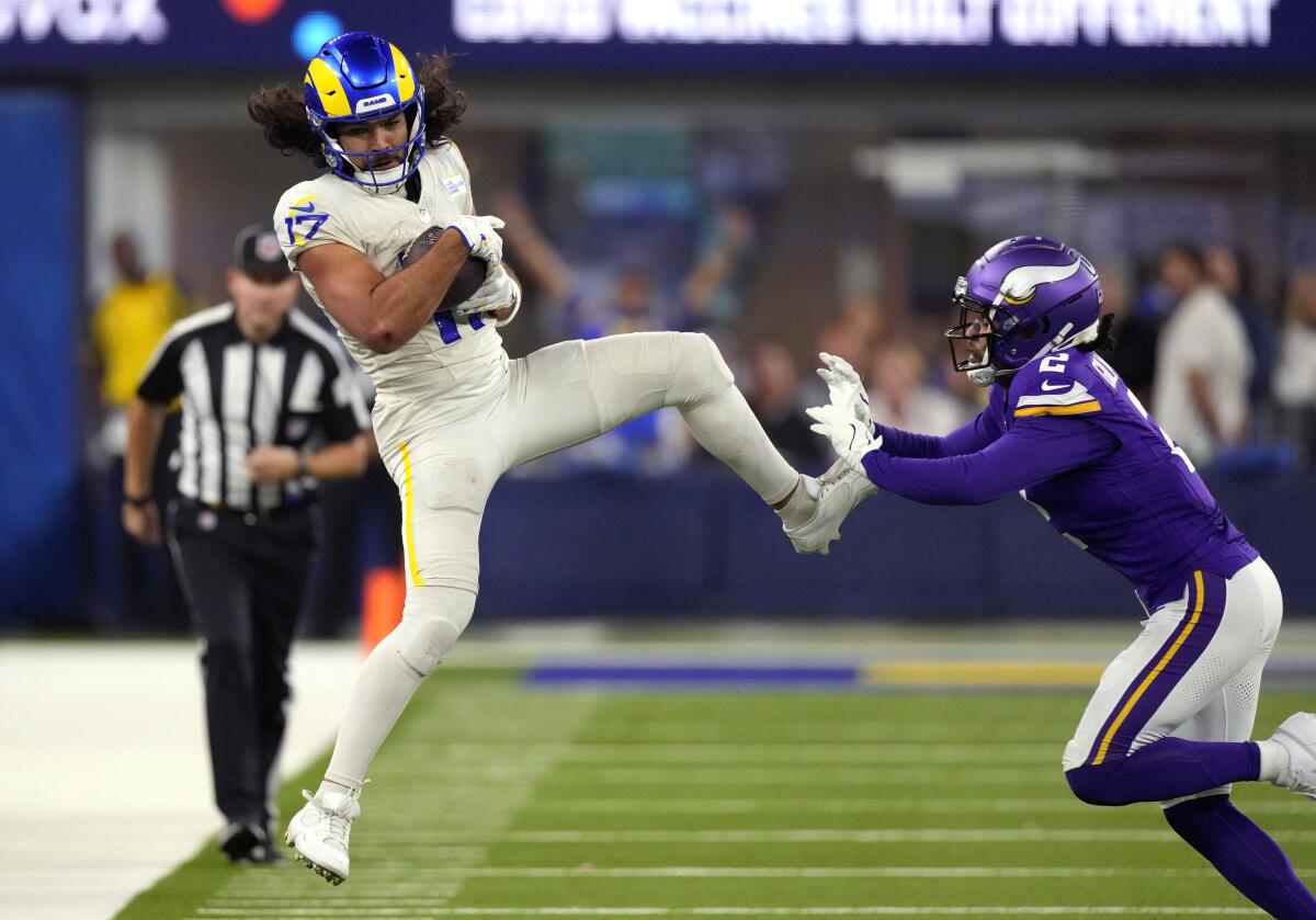 Rams receiver Puka Nacua (17) catches a pass as Vikings cornerback Stephon Gilmore (2) pursues. 