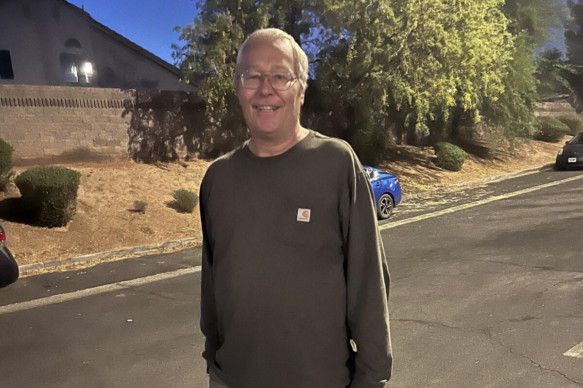 A smiling man standing in the street