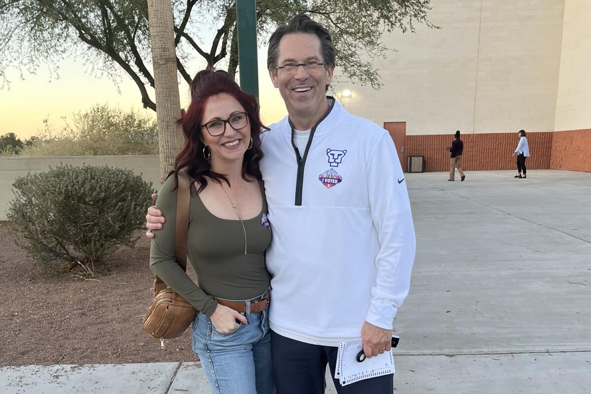 A woman and her father smiling for a photo