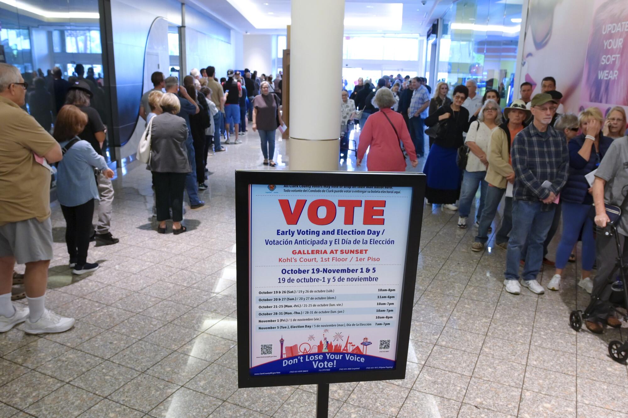 Hundreds of voters stand in line at the Galleria at Sunset mall on Saturday in Henderson, Nev.