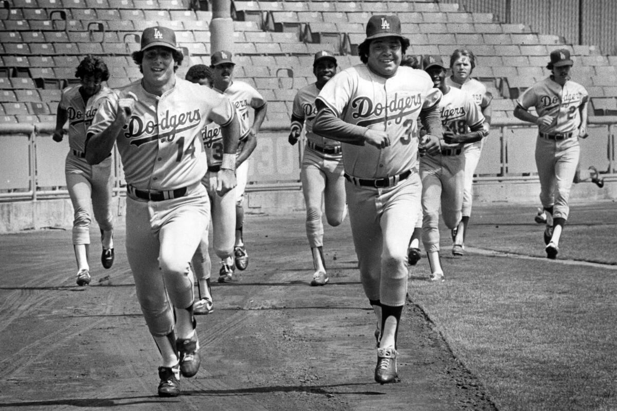 Dodger pitcher Fernando Valenzuela races with Mike Scioscia in their first full workout since.