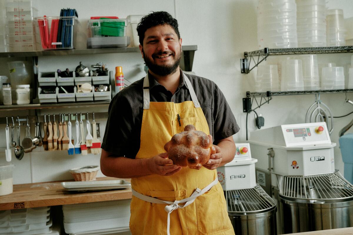  Arturo Enciso holds a food item 