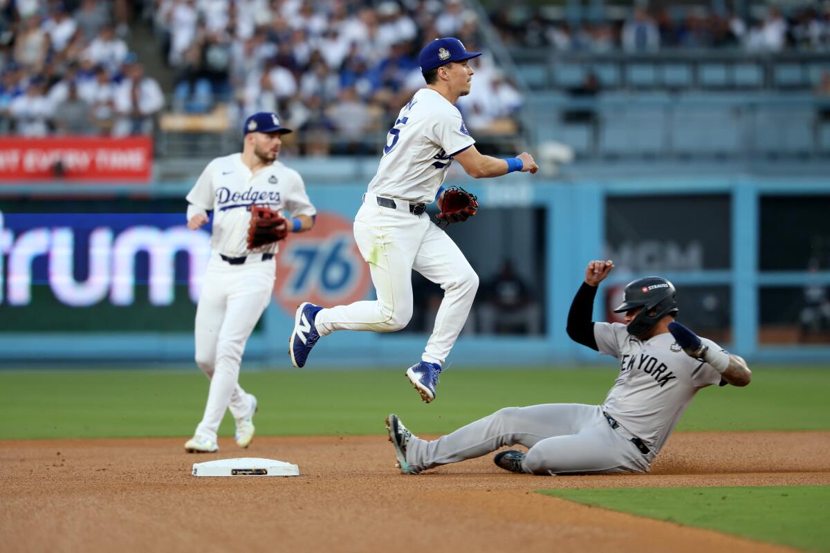 Dodgers shortstop Tommy Edman throws to first base to complete a double play at Dodger Stadium.