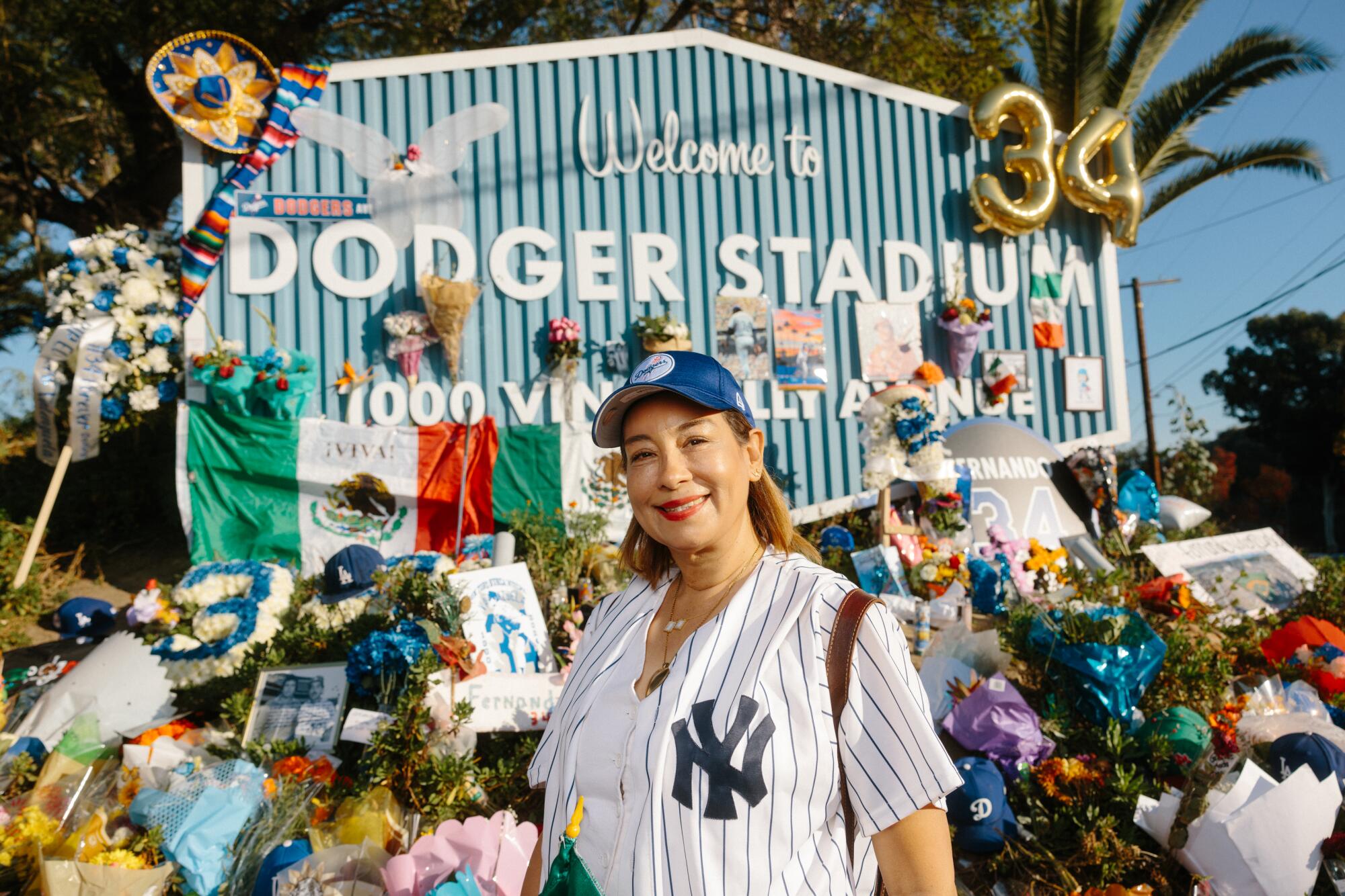 Lizette Duenas in a New York Yankees jersey in front of flowers at Dodger Stadium