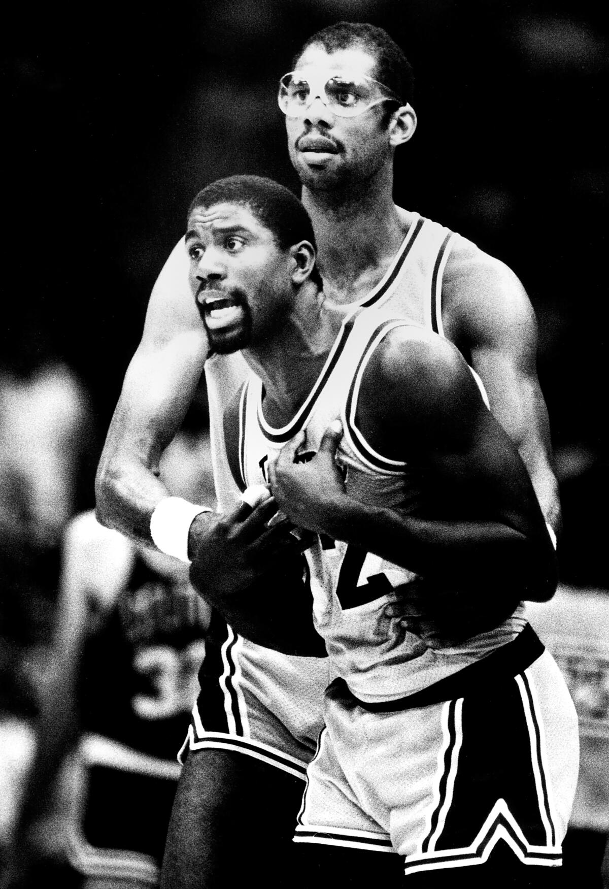 Kareem Abdul–Jabbar restrains Magic Johnson from going after the ref, as a technical foul was called on Magic in 1985