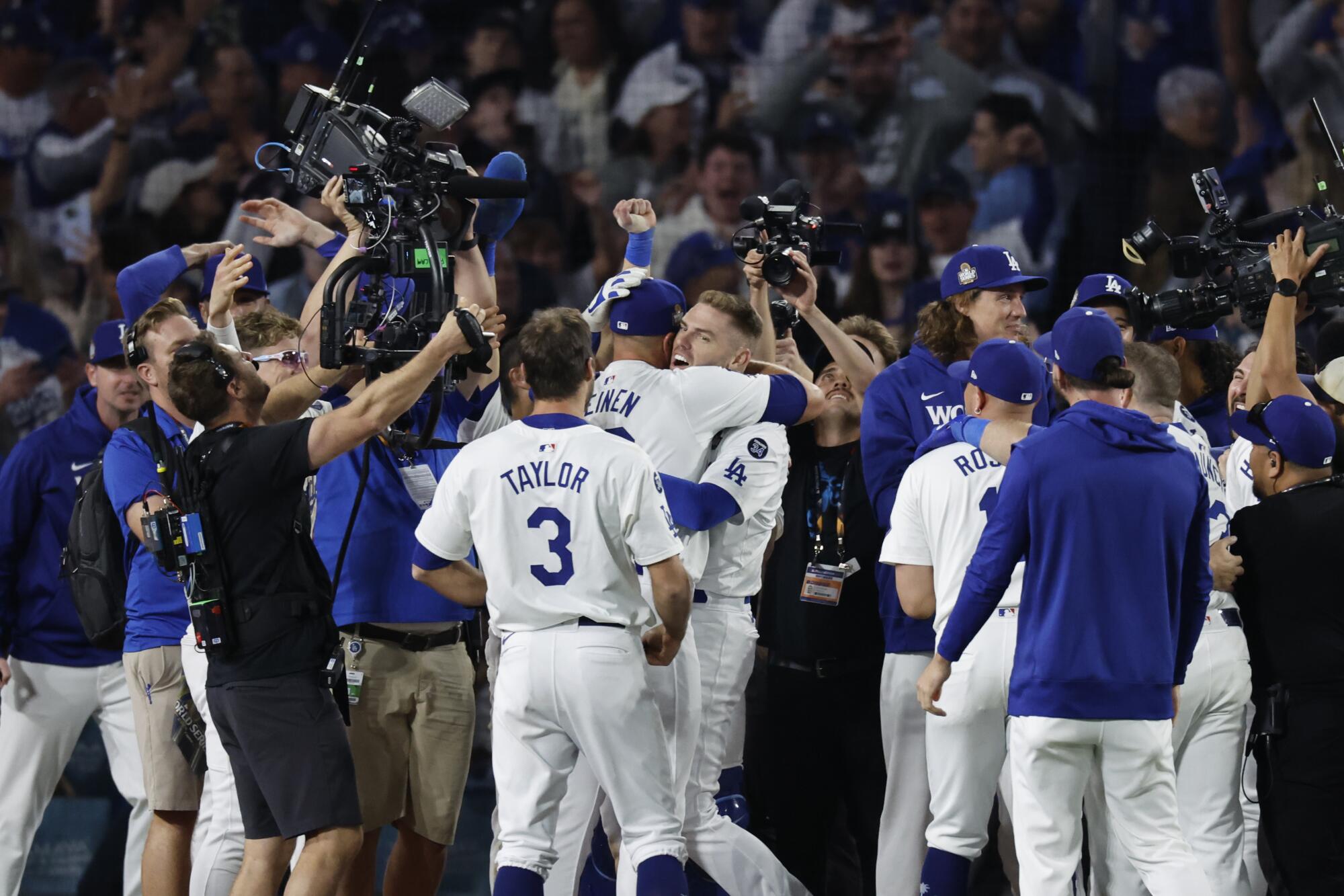 Dodgers reliever Blake Treinen hugs Freddie Freeman at the end of the Dodgers' win in Game 1 of the World Series on Friday.