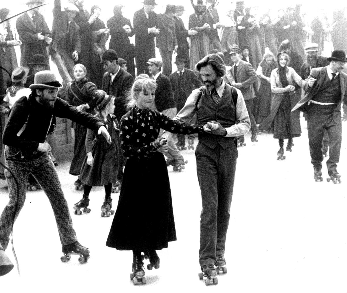 A man and a woman rollerskate in a frontier town.