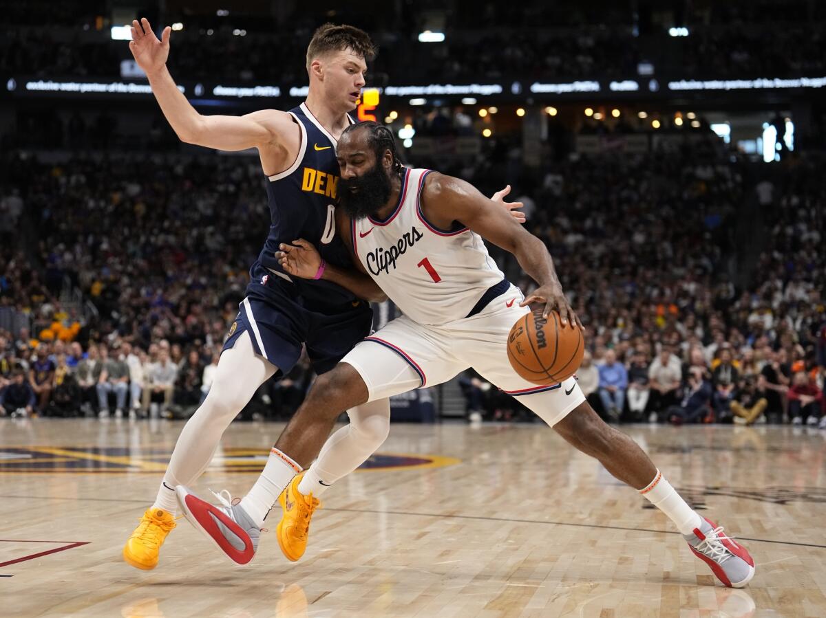 Clippers guard James Harden, right, tries to drive to the basket against Nuggets guard Christian Braun, left, on Saturday