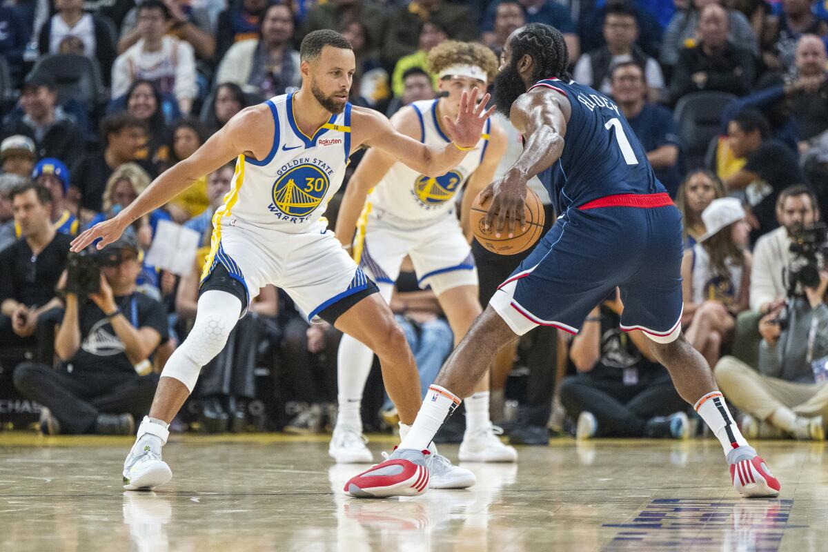 Golden State Warriors guard Stephen Curry defends against Clippers guard James Harden.