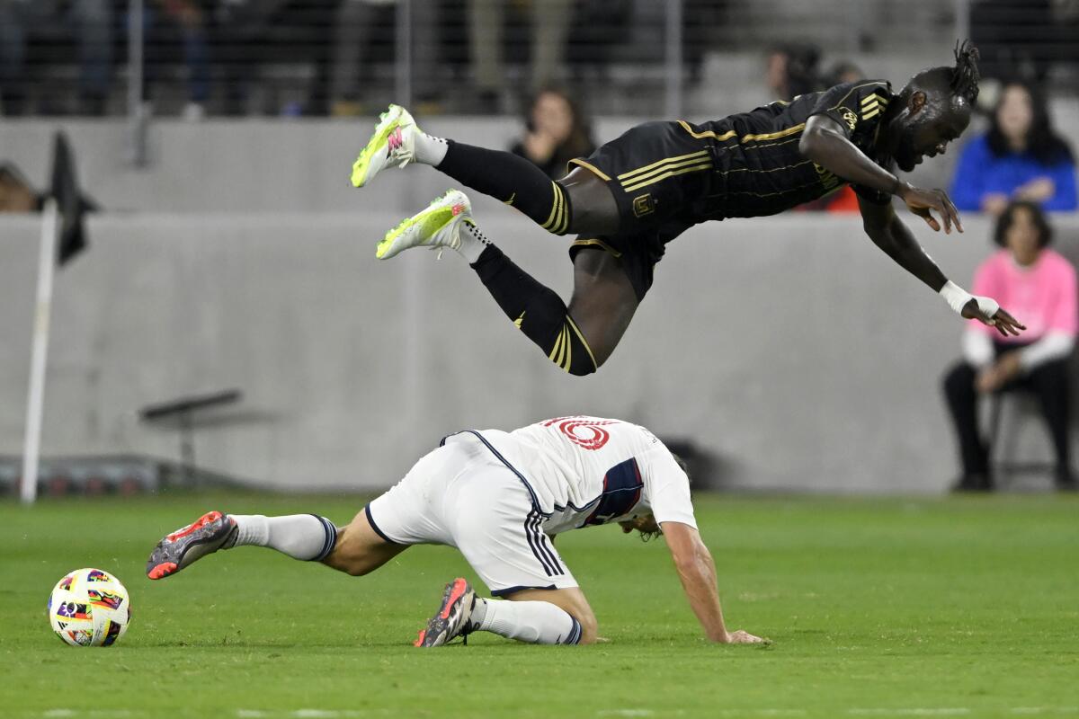 LAFC forward Kei Kamara, top, goes airborne over Vancouver midfielder Sebastian Berhalter during the second half Sunday.