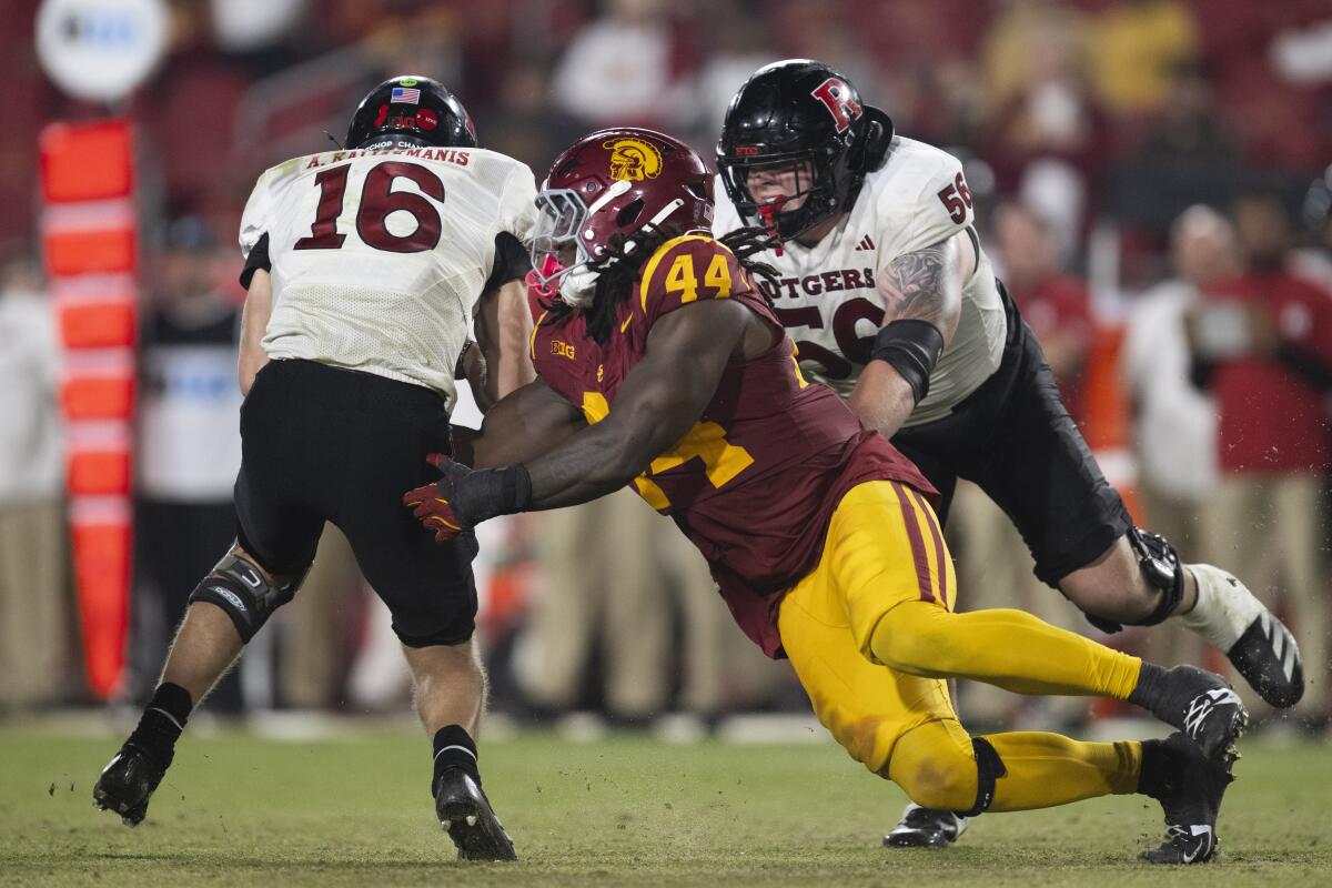 USC defensive end Sam Greene sacks Rutgers quarterback Athan Kaliakmanis.