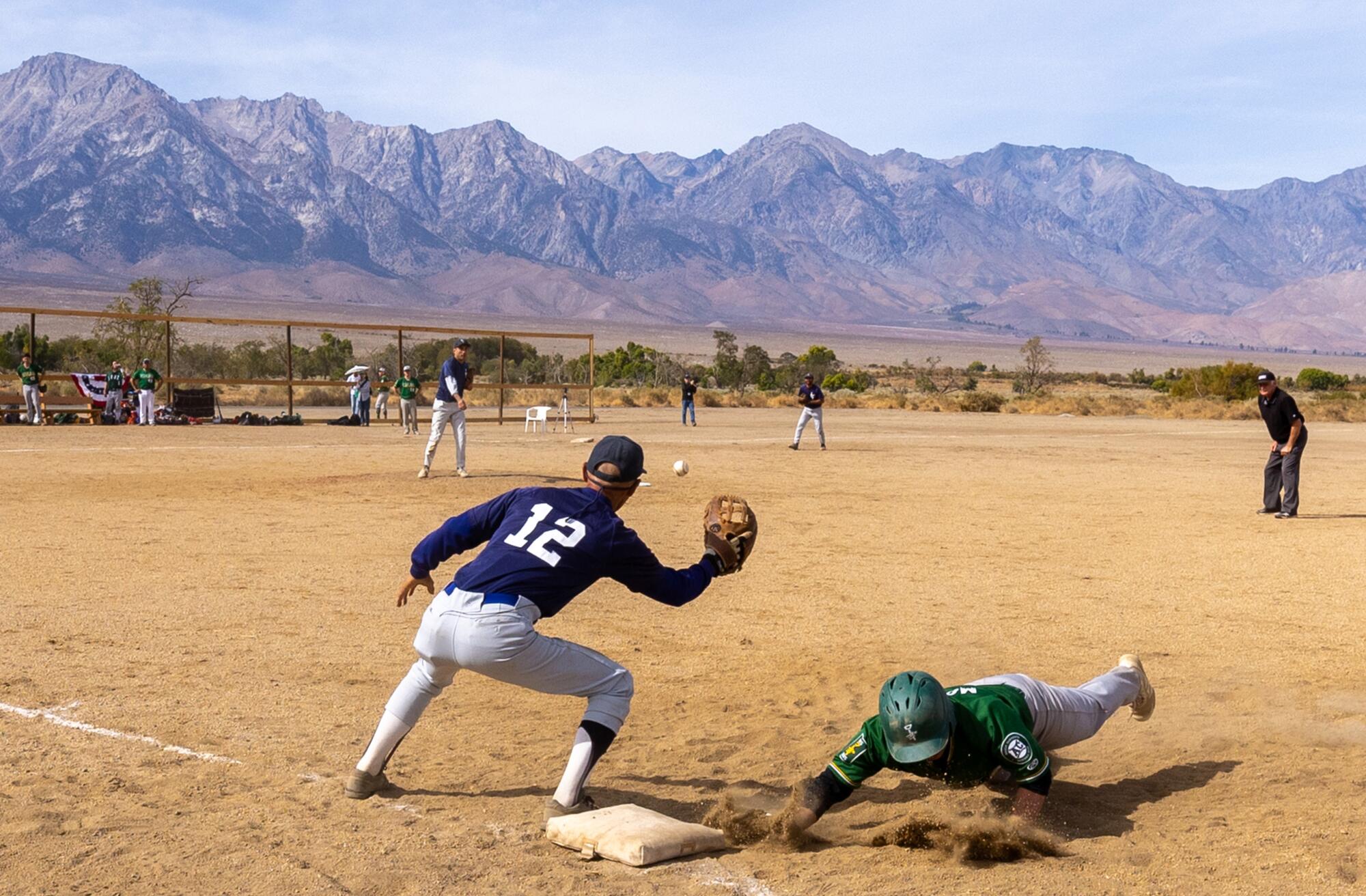 Li'L Tokyo Giants first baseman Dan Kwong, left, fields a pick-off throw at the newly restored baseball fields at Manzanar.