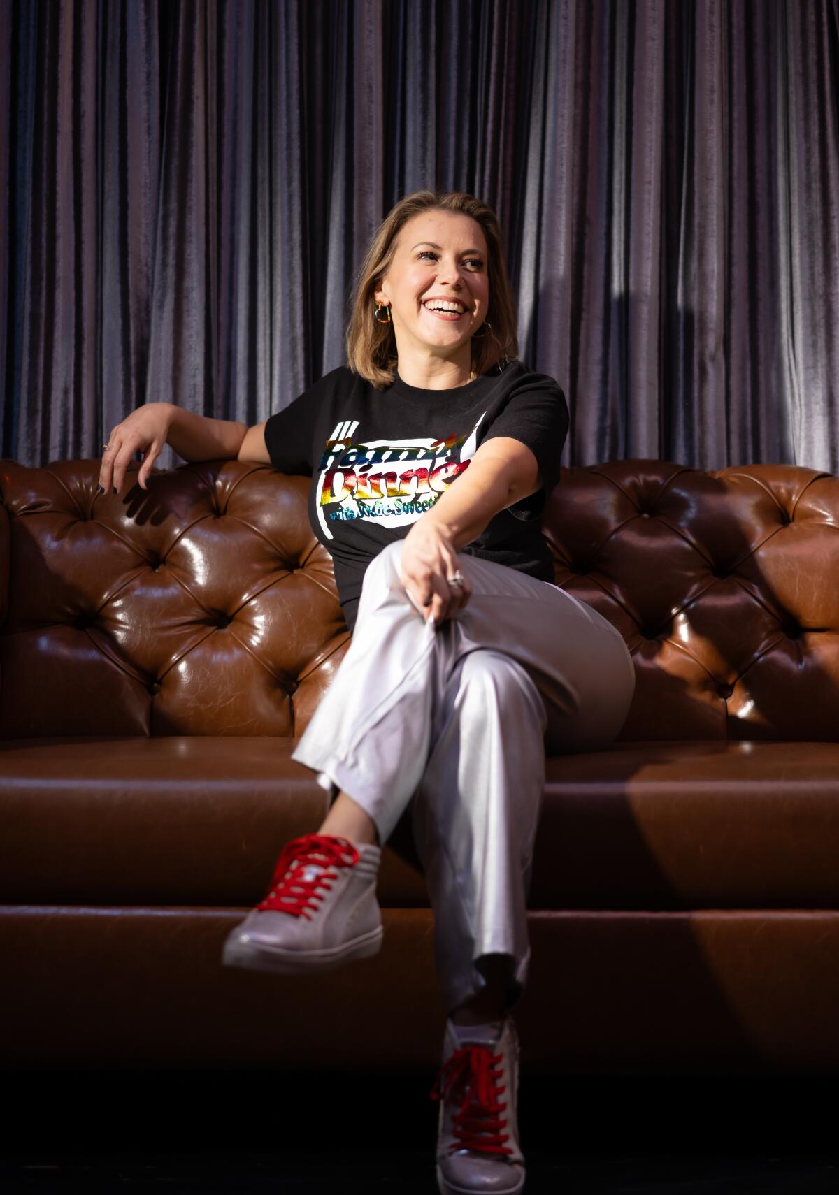 Female comic sitting on a couch